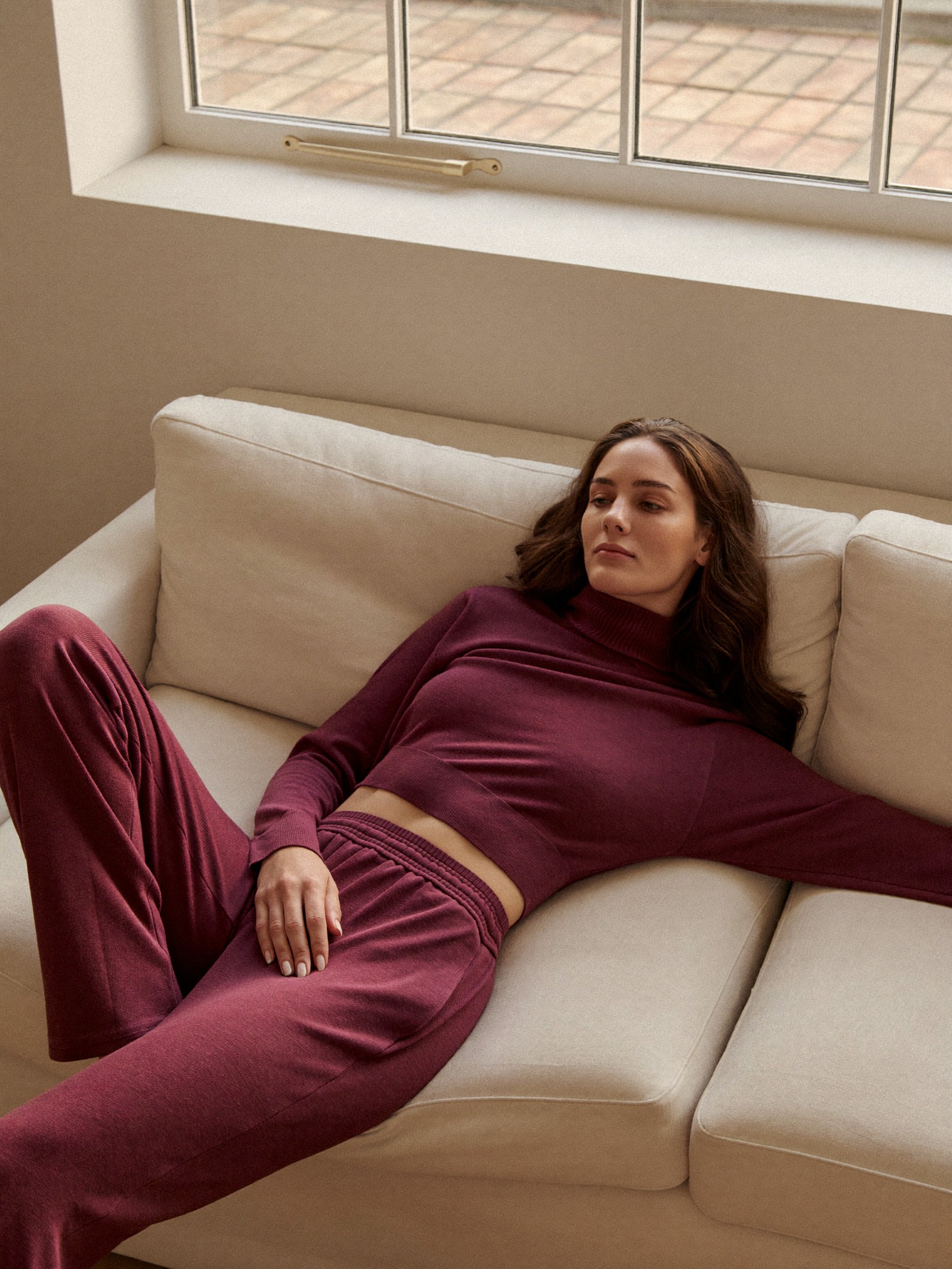 A woman resting calmly at home, no longer carrying the weight she used to