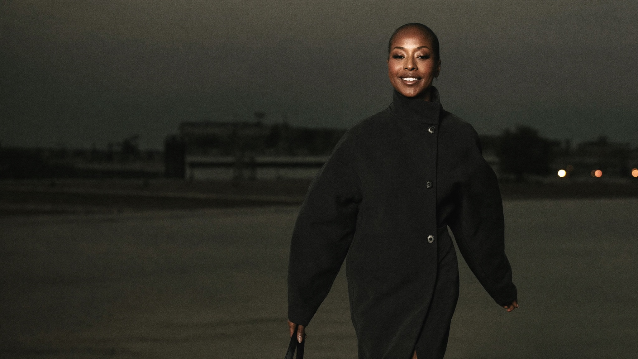 A confident woman moving forward with purpose, carrying less than she used to